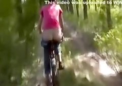 Kinky Girl with Naked Ass Rides the Bicycle Outdoors